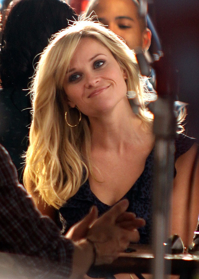 Reese Witherspoon, blue and black blouse, sleeveless blouse, gold hoop earrings, this means war